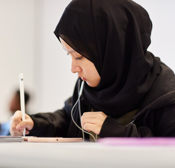 Student looking down writting